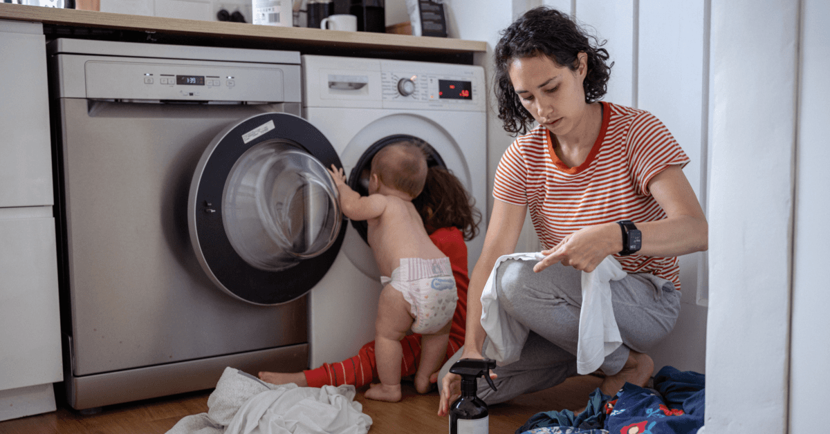 Mother and her son and daughter do laundry together washing clothes from jobsites with asbetos possibly in clothing for husband