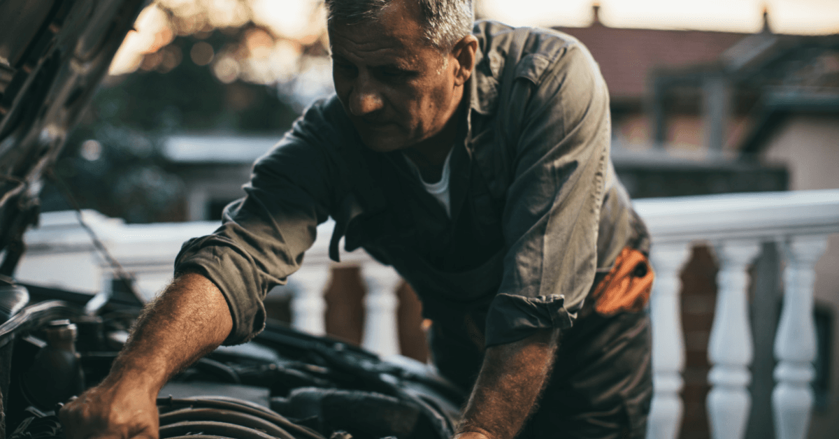 auto mechanic working on a car at risk of asbestos exposure