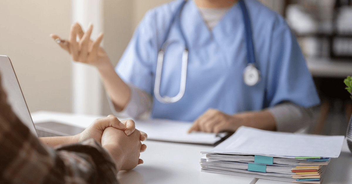 Close-up hand image of a serious patient having a medical consultation with a doctor