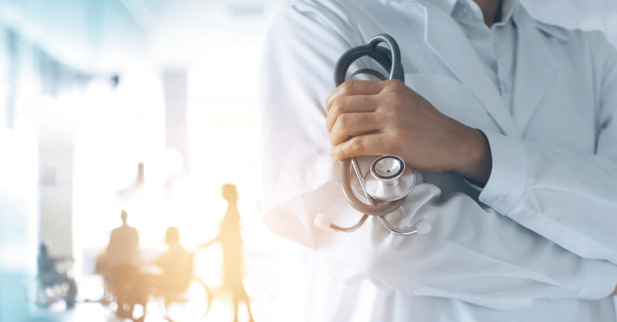 a doctor holding a stethoscope in a hospital