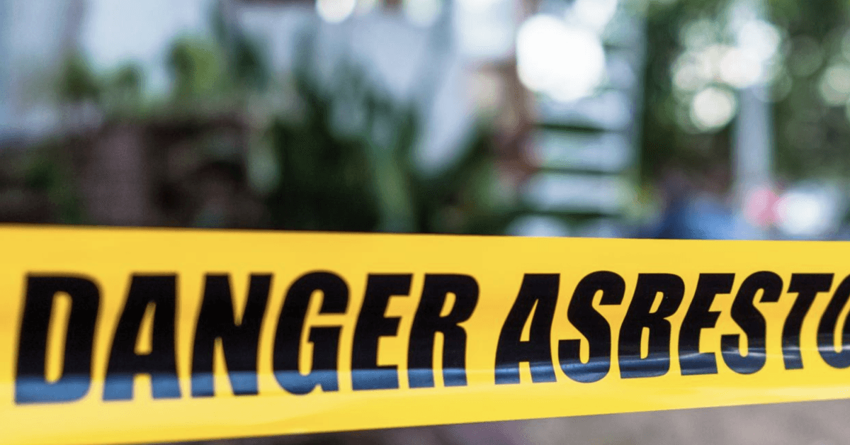 Danger Asbestos warning tape barrier stock photo