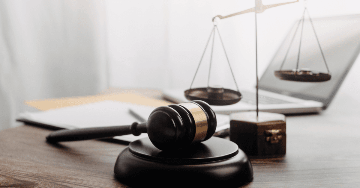 lawyers discussing contract papers with brass scale on desk in office. Law, legal services, advice, justice and law concept picture