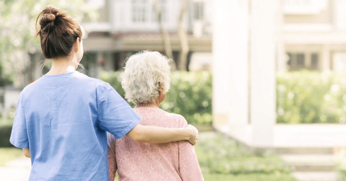 healthcare worker assisting a senior women diagnosed with mesothelioma